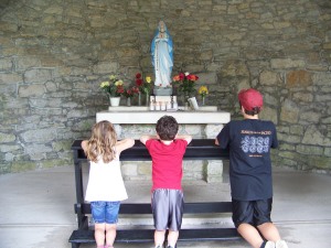 Prayer before the shrine of St. Terese